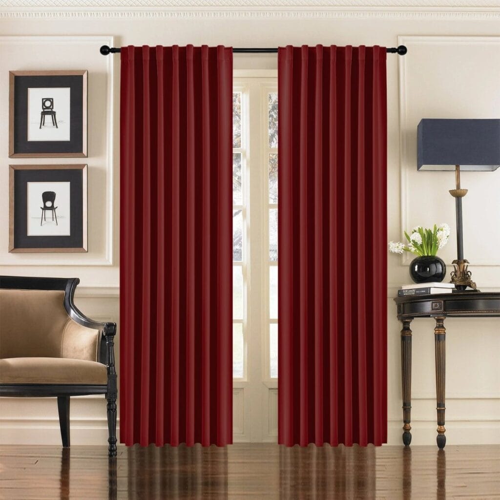 Sleek residential window frame showing how an integrated pair of thermal curtains burgundy red blocks street glare perfectly.