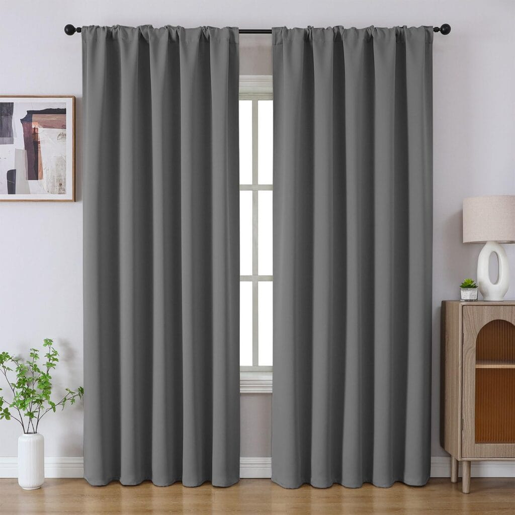 Sleek residential window frame showing how an integrated pair of thermal curtain light grey blocks street glare perfectly.