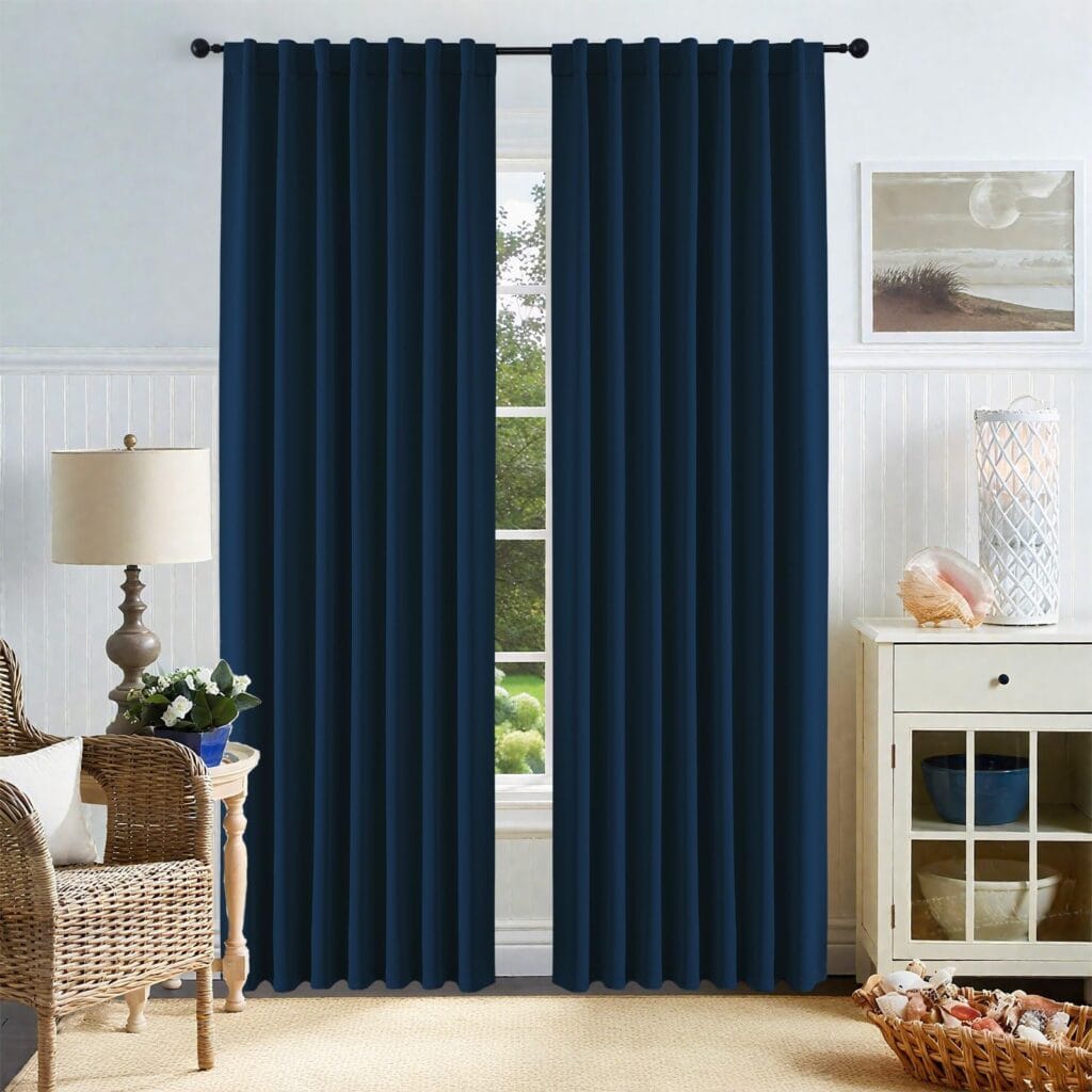 Beautifully arranged apartment interior featuring the clean straight hang of a premium thermal curtains navy blue set.