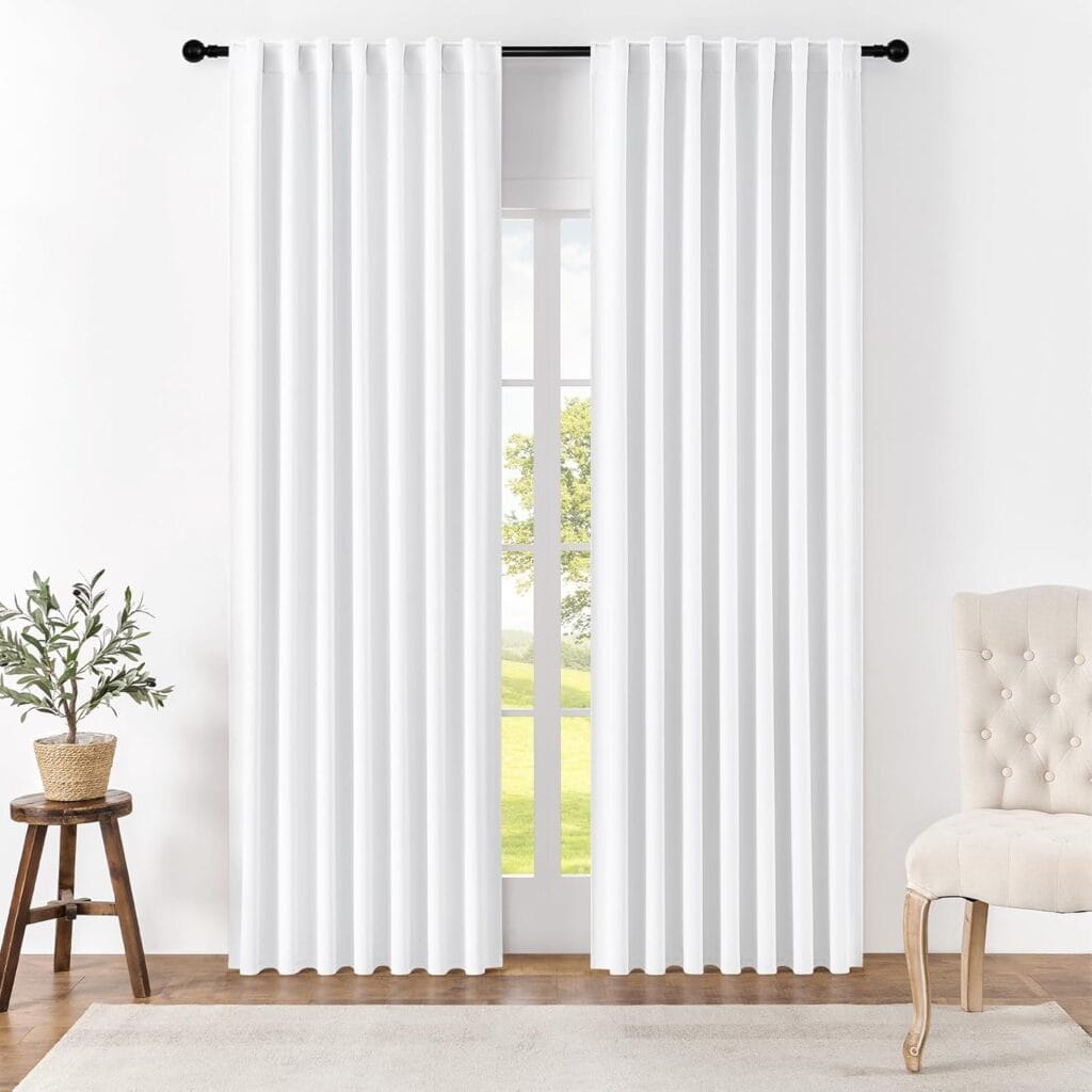 Sleek residential window frame showing how an integrated pair of thermal curtains pure white blocks street glare perfectly.