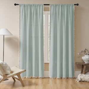 Detailed macro view highlighting the rich textile texture of clean ice blue boho sheer curtains hung in a contemporary bedroom.
