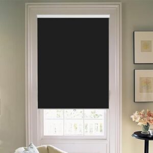 A modern well-lit home interior showing functional blackout roller shade black mounted clean over a residential glass window frame.