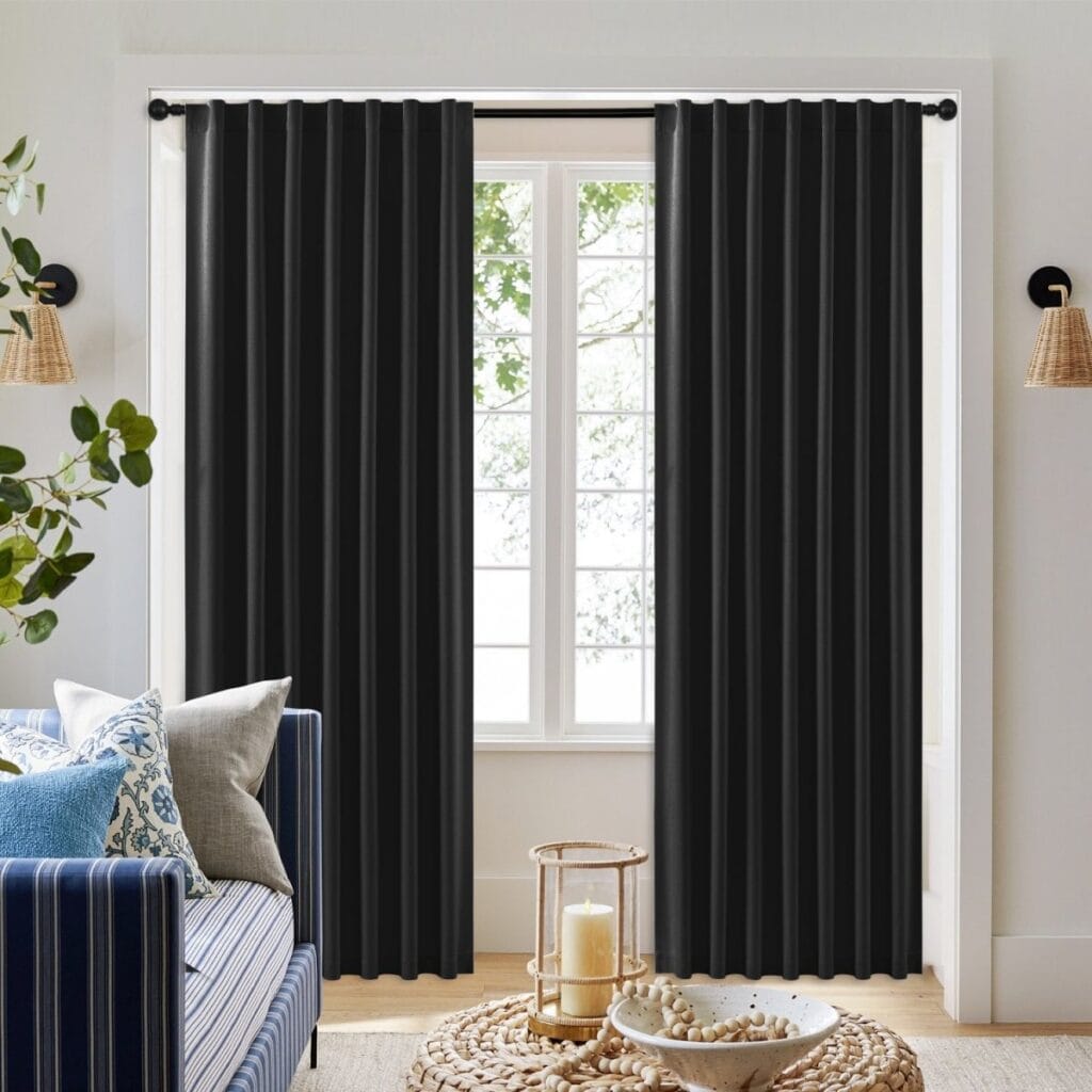 Sleek architectural living zone highlighting how a high-quality set of black curtains back tab offers complete glare protection.