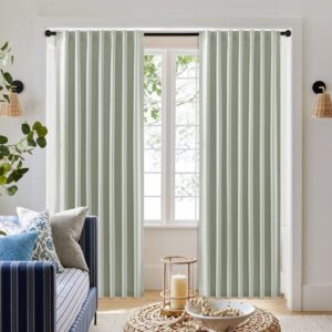 Nicely styled home layout focusing on the clean horizontal folds of a custom-hung sage green curtains back tab drape set.
