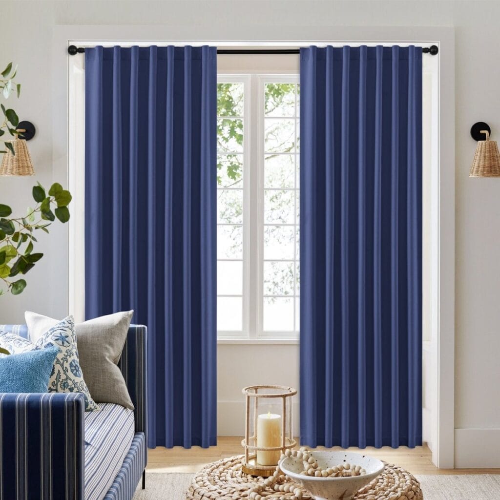 A bright living room space displaying elegant twilight blue curtains hanging beautifully by a modern window layout.
