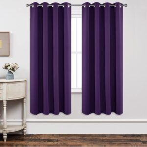 A polished residential bedroom layout featuring a beautiful blackout dark purple curtain drawn shut to secure total rest.