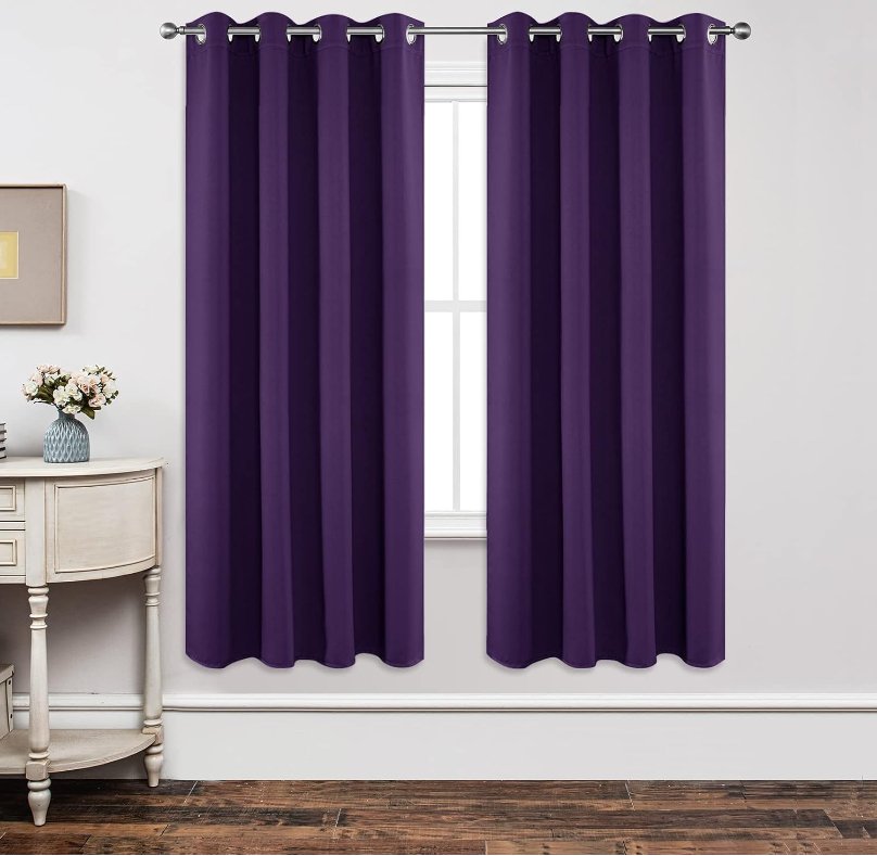 Joydeco Custom Blackout Back Tab Rod Pocket Curtain - Dark Purple 1 A polished residential bedroom layout featuring a beautiful blackout dark purple curtain drawn shut to secure total rest.