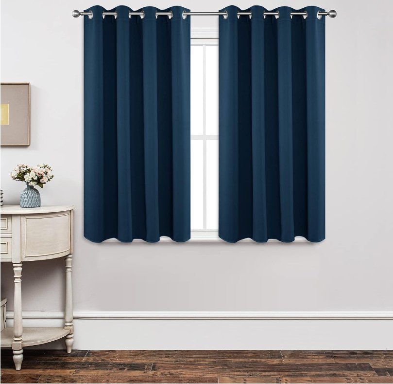 Joydeco Custom Blackout Back Tab Rod Pocket Curtain - Navy Blue 1 Close-up fabric macro visual highlighting the heavy drape and neat weave of a hung blackout navy blue curtain.