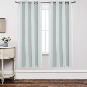Joydeco tailored window treatment displaying an elegant blackout off white curtain installed over a clean casual setting.