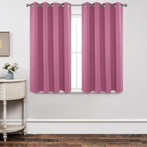 A polished residential bedroom layout featuring a beautiful blackout pink curtain drawn shut to secure total rest.