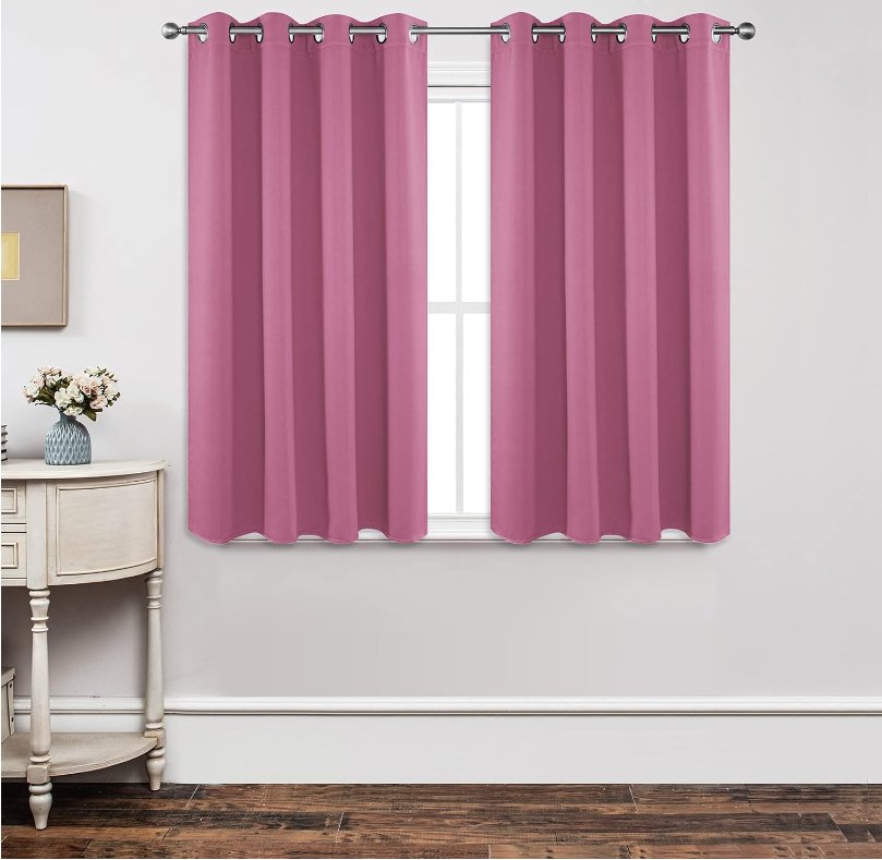 Joydeco Custom Blackout Back Tab Rod Pocket Curtain - Pink 1 A polished residential bedroom layout featuring a beautiful blackout pink curtain drawn shut to secure total rest.