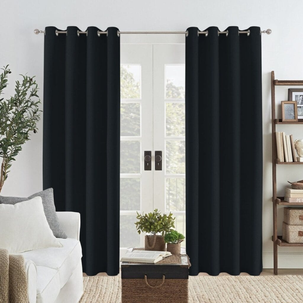 Joydeco functional home visual emphasizing an elegant linen blackout curtain black hanging gracefully over a minimalist setting.