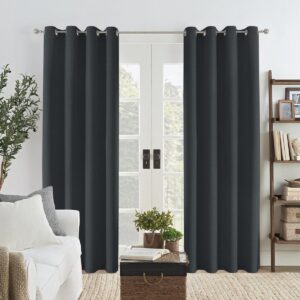 A bright living room space displaying elegant faux linen charcoal grey hanging beautifully by a modern window layout.