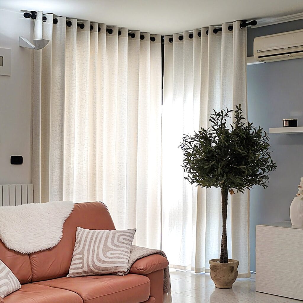 Joydeco elegant home interior display highlighting high-quality ivory semi sheer linen panel cascading beautifully over a window setting.