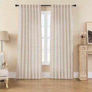 Nicely decorated corner nook highlighting the soft light-filtering weave pattern of a custom-hung light beige linen curtain.