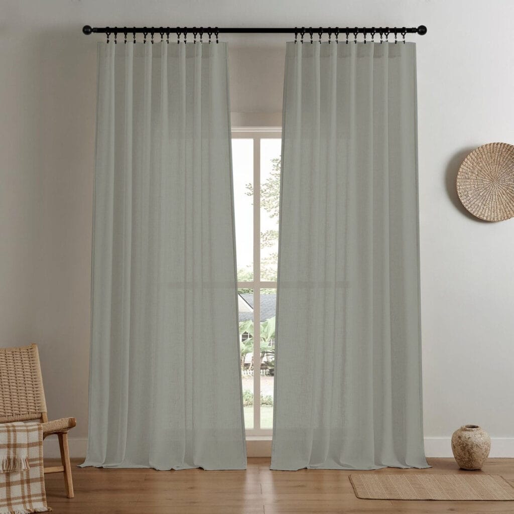 A modern home interior showing high-quality linen filtering curtain grey installed clean across a bright window frame.