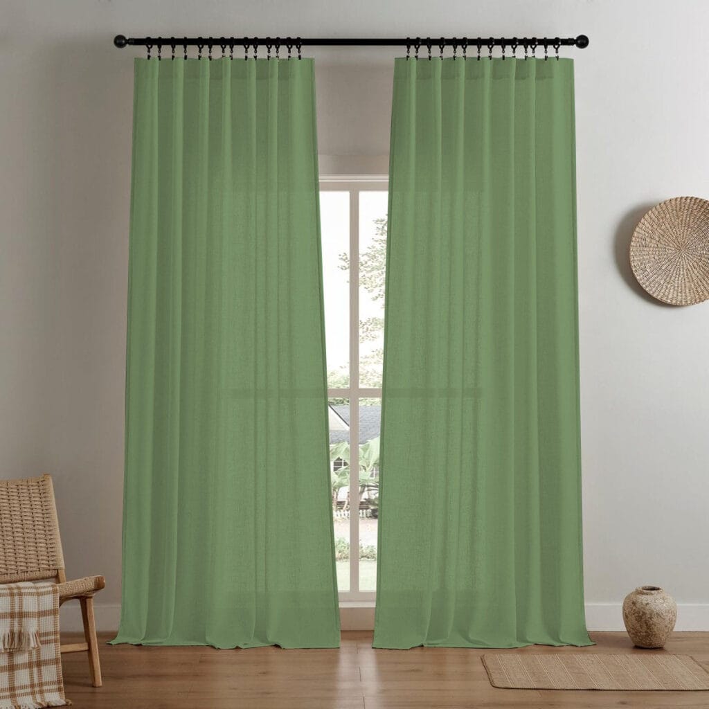 A modern home interior showing high-quality linen curtain sage green installed clean across a bright window frame.