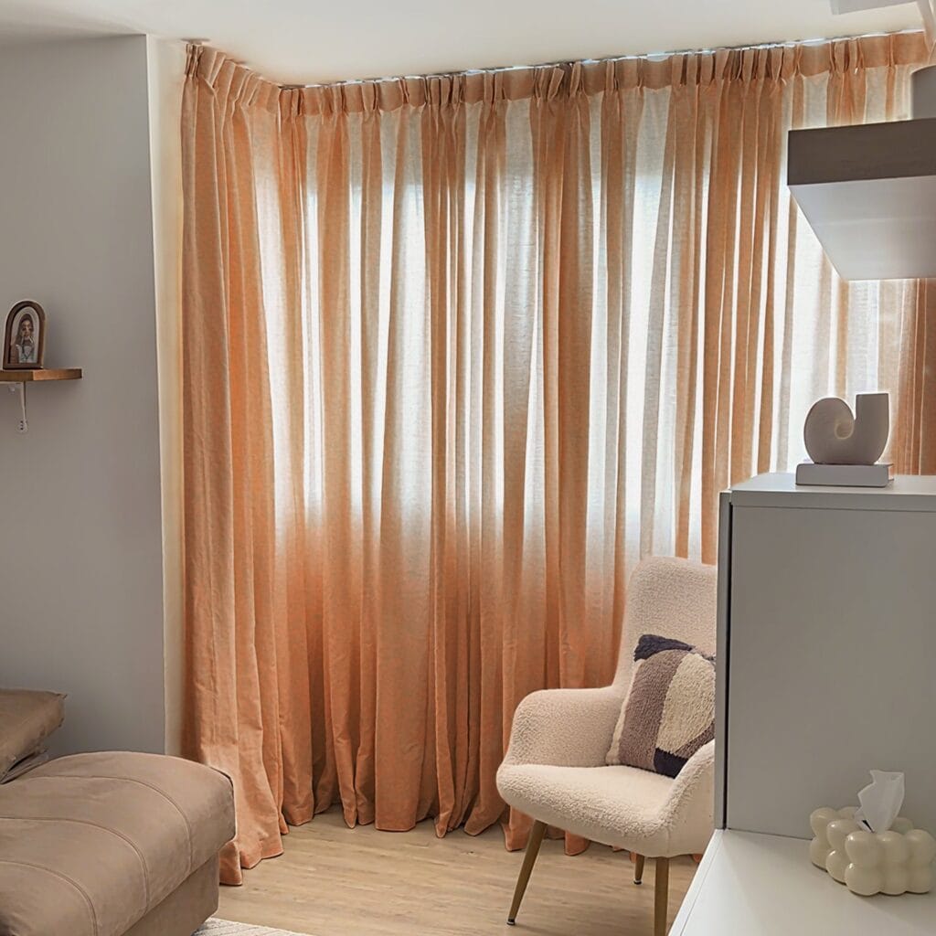 Nicely decorated corner nook highlighting the soft light-filtering weave pattern of a custom-hung pottery semi sheer curtains.