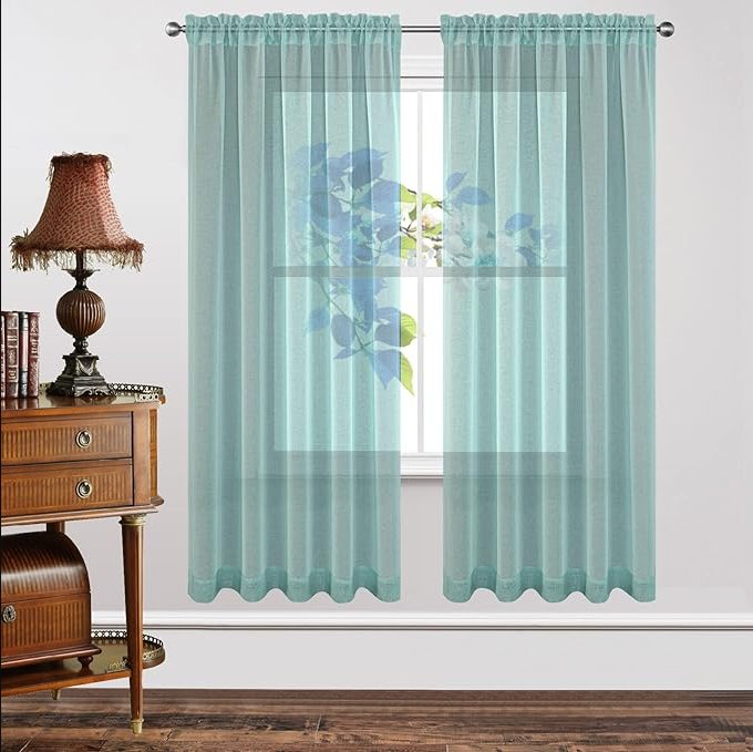 Joydeco Custom Sheer Curtain - Teal Blue 1 Close-up fabric macro shot of a styled teal blue sheer curtain hanging gracefully on a metallic curtain rod.