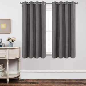 A bright living space window adorned with a gorgeous grey thermal blackout curtain filtering daylight beautifully.