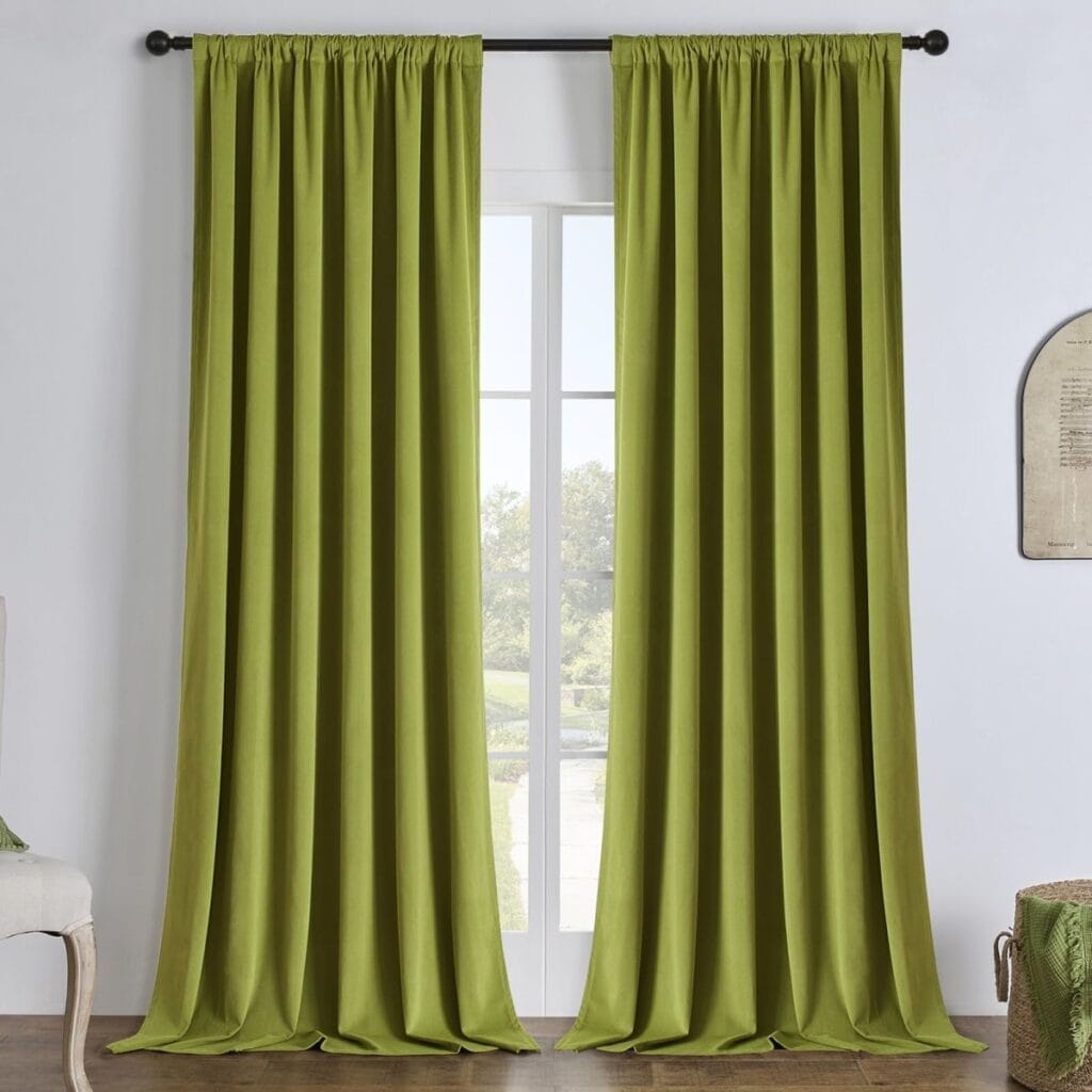 A tailored residential window layout showcasing beautiful velvet blackout olive green installed cleanly across a sunlit room.