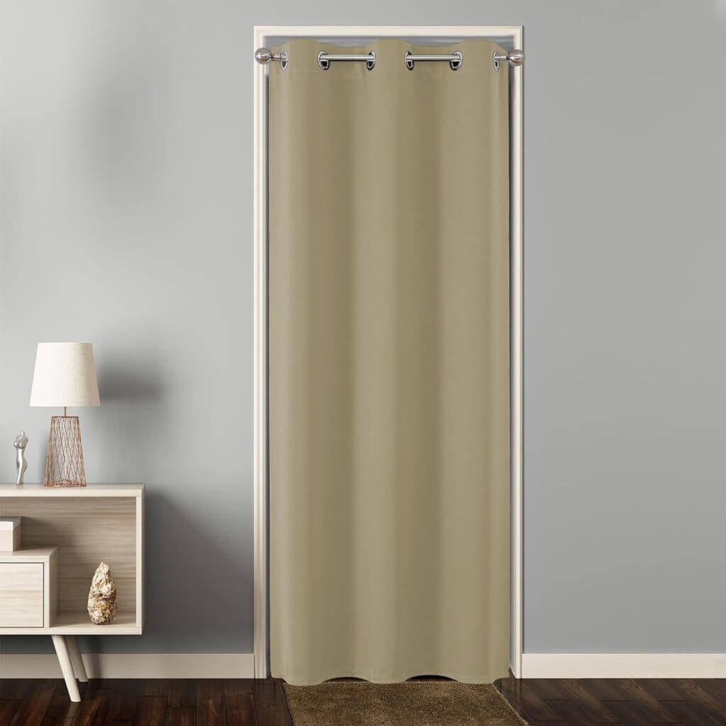 Elegant interior space presenting well-fitted extra wide beige curtains hung clean on a black industrial curtain rod.