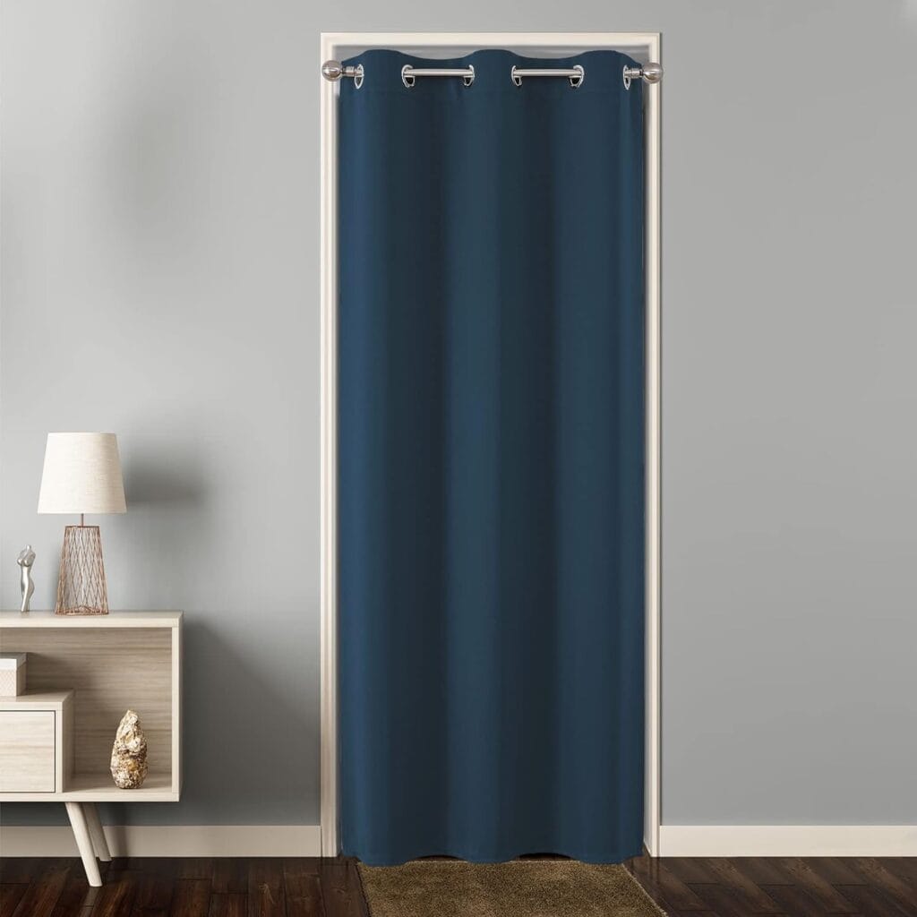 Elegantly draped window display focusing on the clean lines of extra wide navy curtains framing a scenic backyard view.