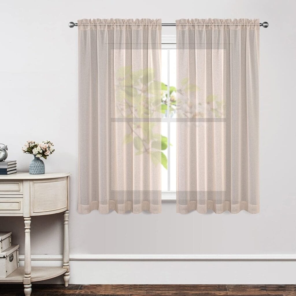 Luxury modern interior featuring high-quality floral linen sheer curtains hung over a large patio doorway.
