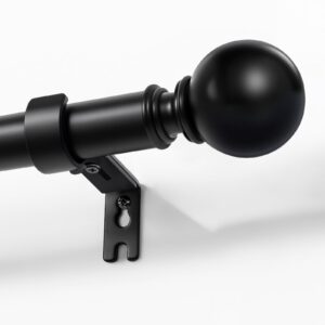A modern well-appointed residential space showcasing functional black patio curtain rod installed cleanly over a window frame.