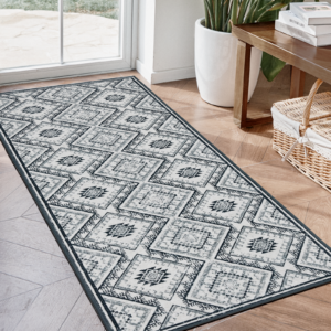 Sleek architectural doorway presentation featuring the elegant long hang profile of a custom-tailored washable rug black white.
