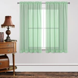 Close-up macro shot focusing on the high-quality fabric grain and neat stitching details of a durable mint green sheer curtains set.