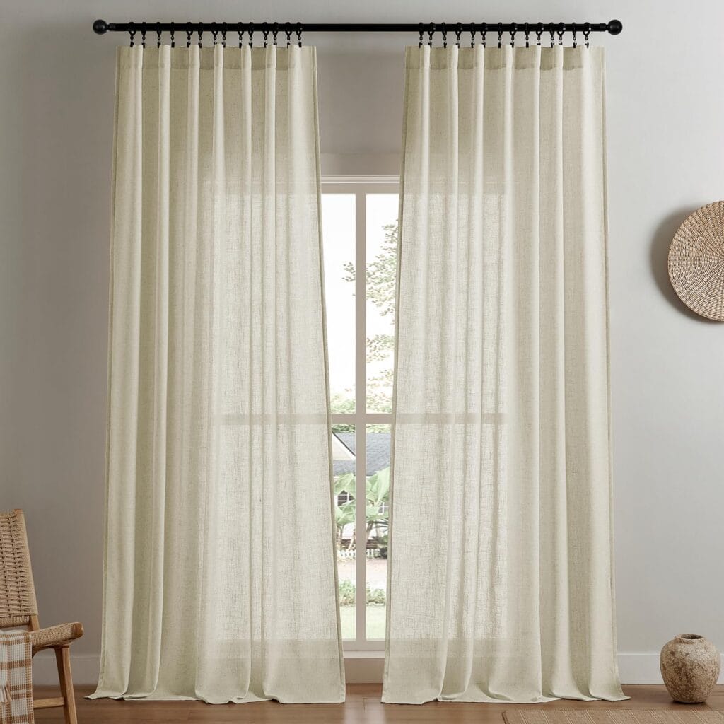 Sleek architectural doorway presentation featuring the elegant long hang profile of a custom-tailored semi sheer linen curtains.