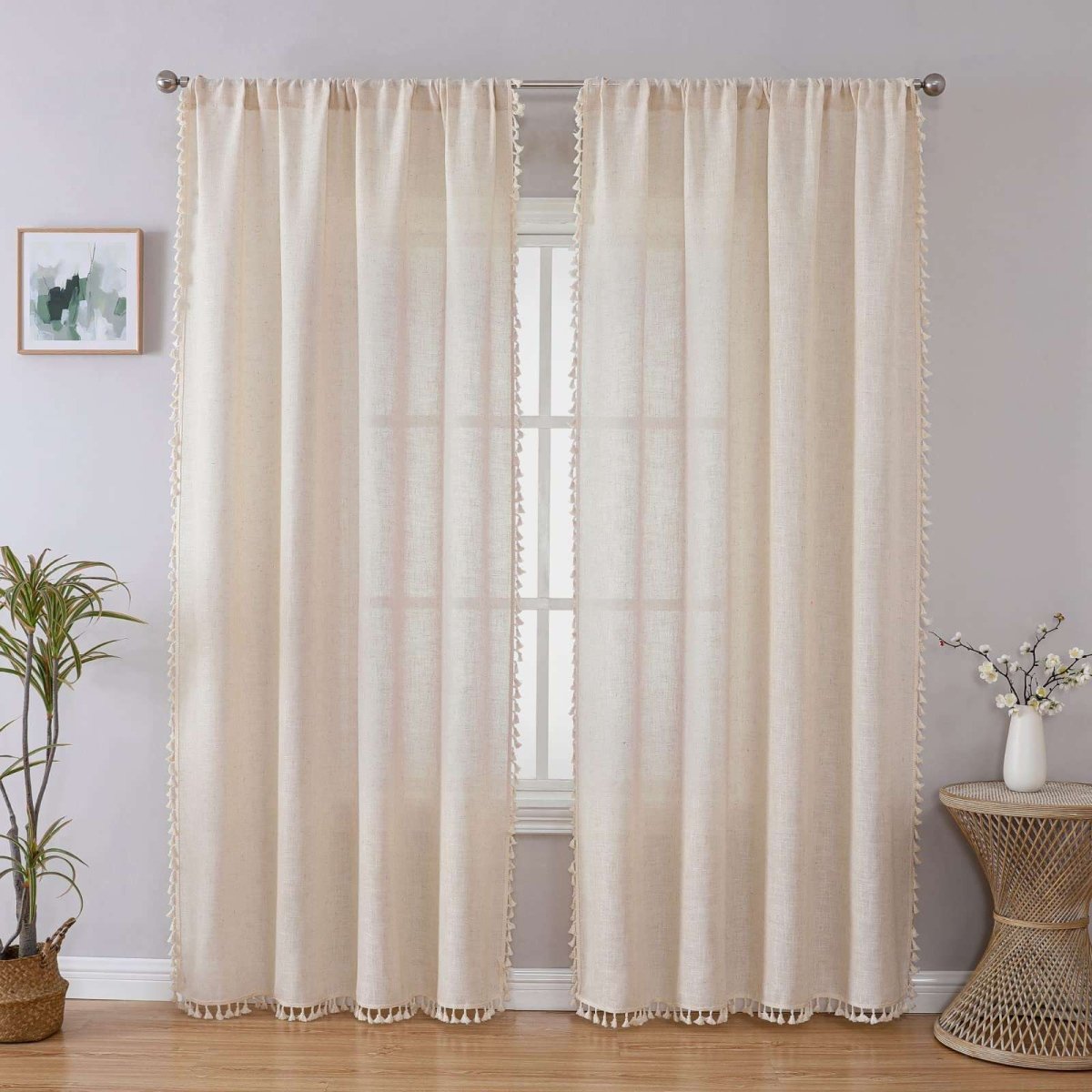 Joydeco Solid Beige Boho Curtains with Tassel Trim and Embroidery - 2 Drapes - Linen 1 A perfectly styled layout showing beige boho tassel curtains hanging by a window in a contemporary interior.