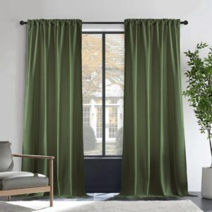 Beautifully styled velvet blackout green olive hanging gracefully on a black metal curtain rod.