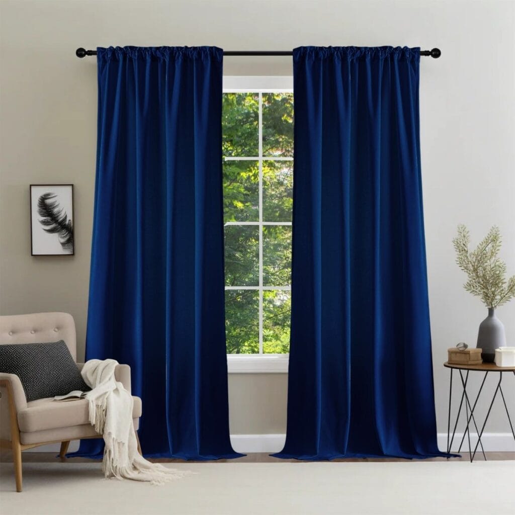 Luxury modern interior featuring high-quality royal blue rod pocket curtains hung over a large patio doorway.