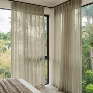 A modern well-lit living area featuring an elegant linen sheer curtain taupe filtering daylight beautifully.