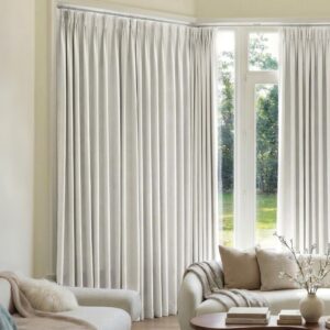 A modern well-lit living area featuring an elegant blackout curtains ivory white filtering daylight beautifully.