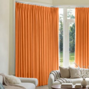 A modern well-lit living area featuring an elegant blackout curtain orange filtering daylight beautifully.