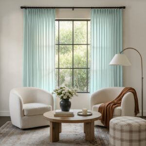 A modern well-lit living area featuring an elegant sheer curtain ice blue filtering daylight beautifully.
