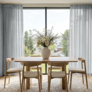 Polished apartment layout focusing on the crisp horizontal fall profile of a tailored sheer curtain greyish white set.
