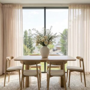Polished apartment layout focusing on the crisp horizontal fall profile of a tailored linen sheer curtain light beige set.