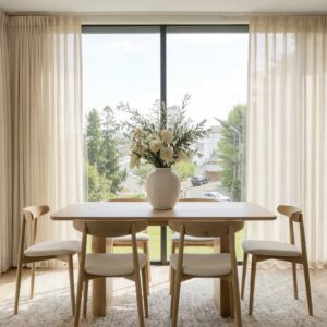 A modern well-lit living area featuring an elegant linen sheer curtain natural filtering daylight beautifully.