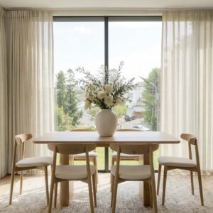 A modern well-lit living area featuring an elegant linen sheer curtain oatmeal filtering daylight beautifully.