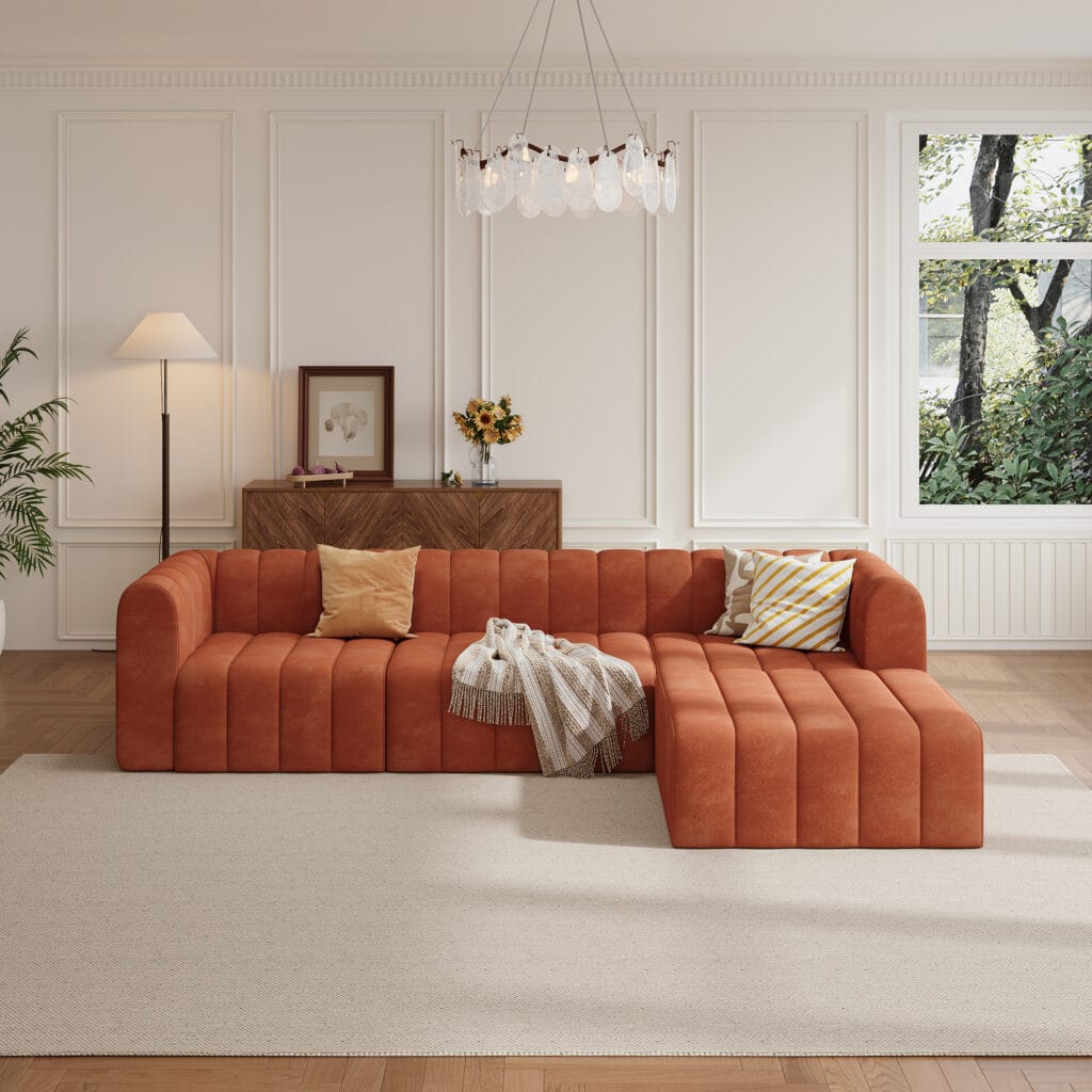 Stylish modern orange velvet sectional sofa featuring a channel tufted design and deep seats.