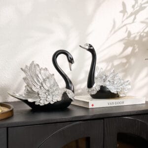 Elegant 2-piece resin décor featuring black silver swan figurines with detailed silver wings.