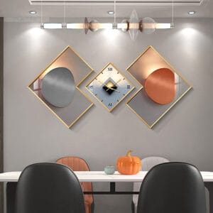 Modern geometric wall clock set featuring three pieces of contemporary art prints and gold frames.
