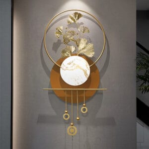 Modern metal wall art featuring golden ginkgo leaves and geometric circular frames.