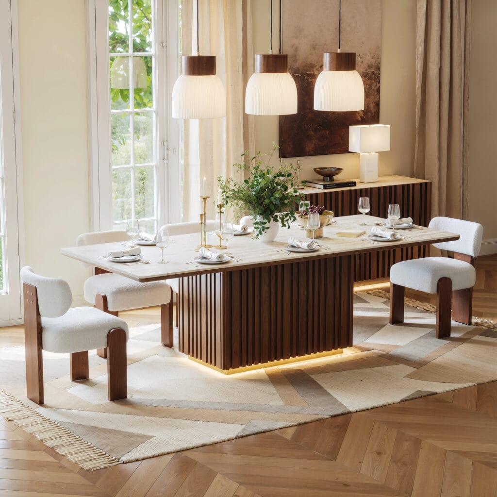 The Sicotas Collection 28 Stylish Aura Faux Travertine Dining Table features a sintered stone top and fluted base.
