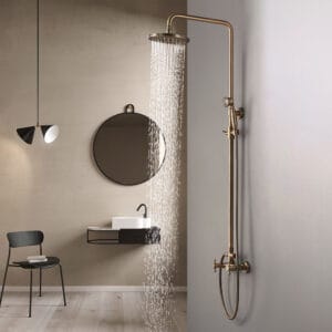 Traditional style shower package featuring an antique brass shower fixture and double cross handles.
