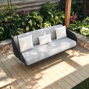 Stylish Cocaro patio swing featuring thick cushions and handwoven all-weather rope.